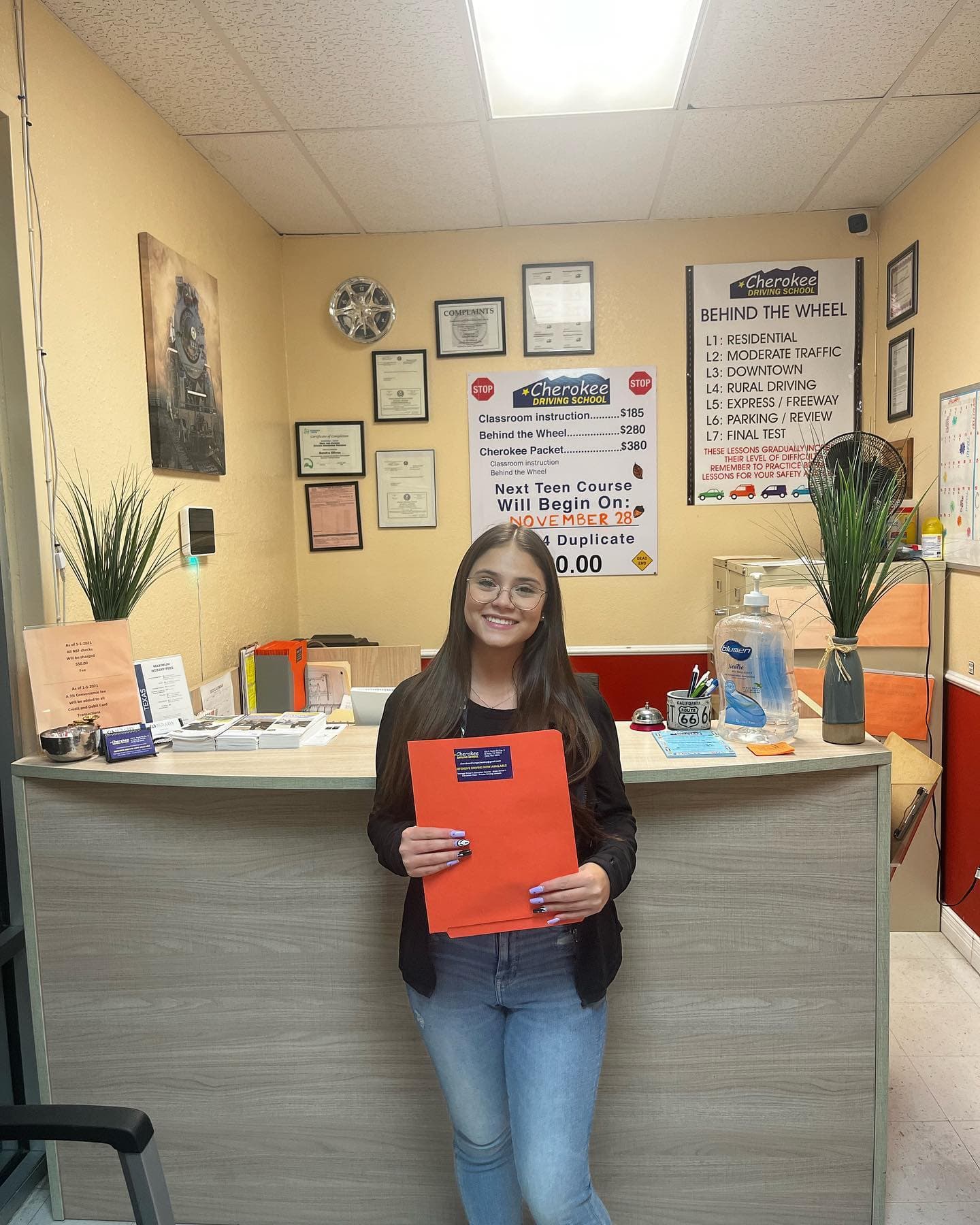 Cherokee Driving School student holding a completed driver education folder
